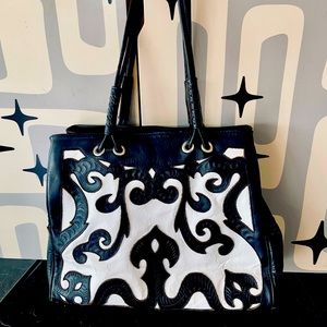 Internationally recognized Leaders in Leather Tuxedo bag.